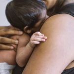 Mom holding newborn baby close
