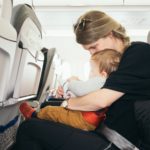 Mom and baby seated on an airplane