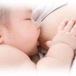 baby nursing on mothers breast