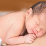 Newborn baby sleeping skin to skin